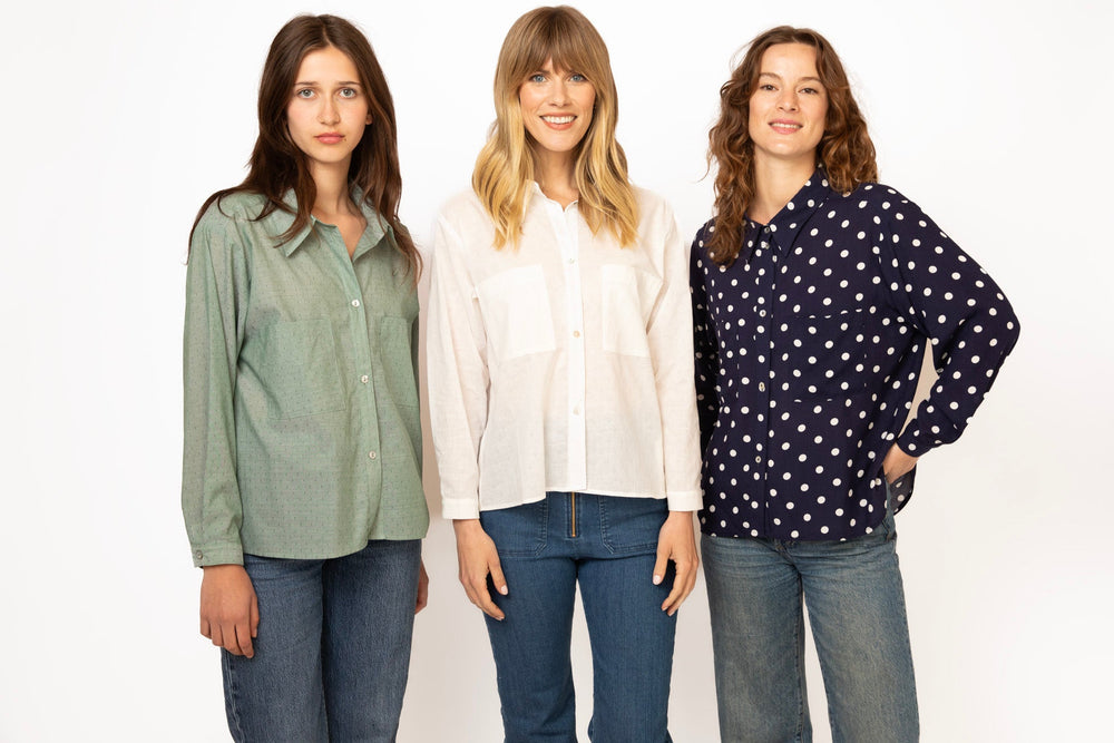 Three women wearing different shirts and jeans on a white background