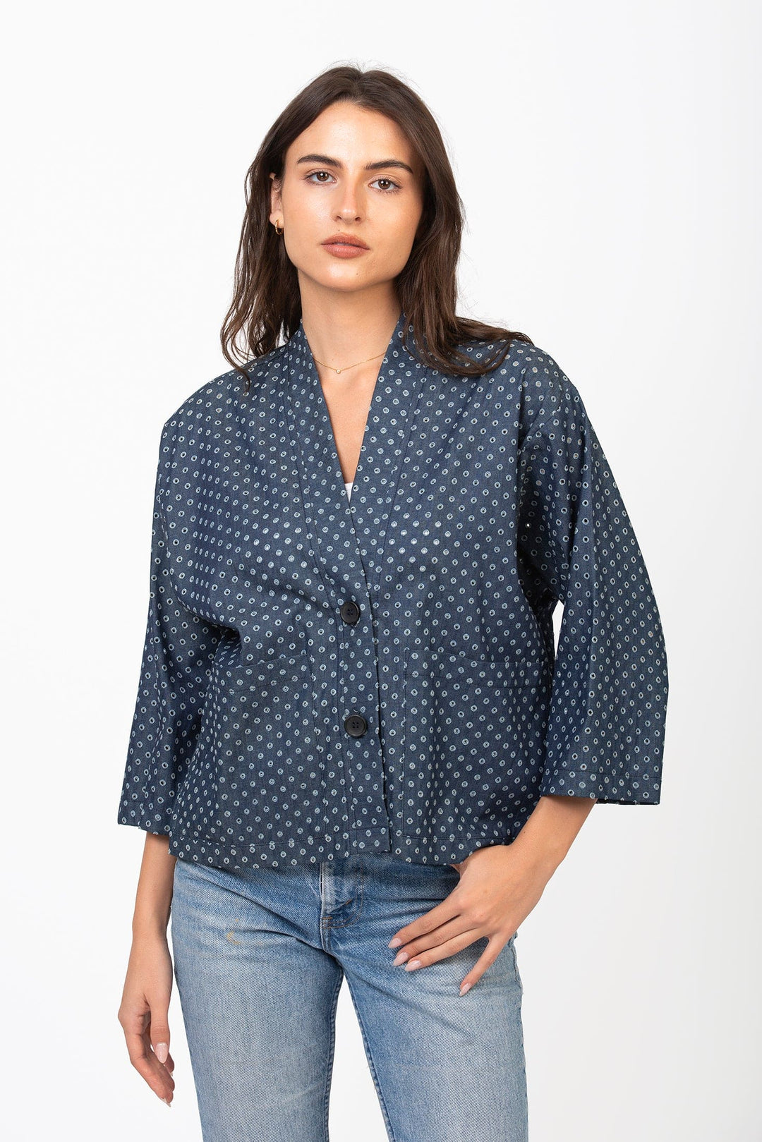 Holey chambray Basket Jacket by Cameo Clothing Line displayed on a hanger, showcasing its relaxed fit and textured fabric.